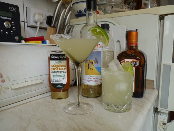 A classic summer cocktail comprising of tequila, triple sec, lime juice and agave syrup.  Seen here in a martini glass and on the rocks, both with a salt rim.
